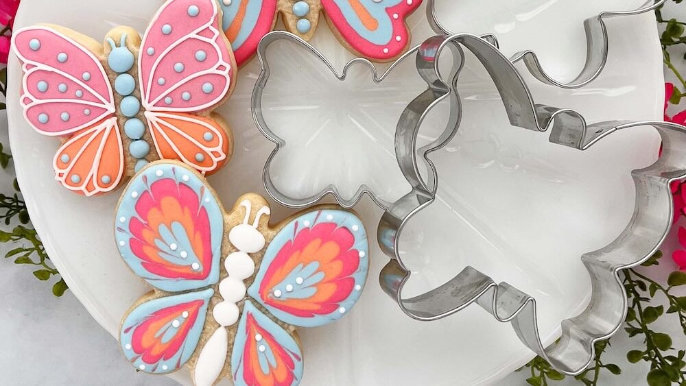 plate of sugar cookies and butterfly cookie cutters
